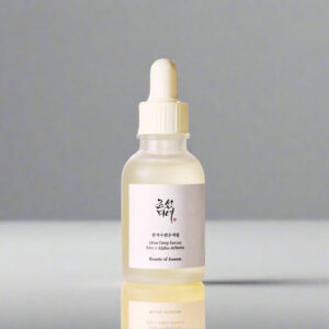 Skincare serum bottle with dropper on a light beige background