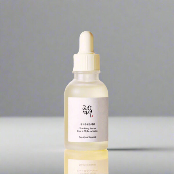 Skincare serum bottle with dropper on a light beige background